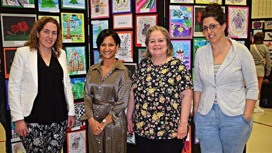 Students proudly dispaly their artwork at vernissage